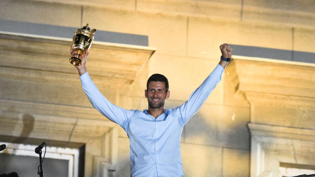 Novak Djokovic holds up the Wimbledon trophy during a ceremony in Belgrade, Serbia. (Reuters)