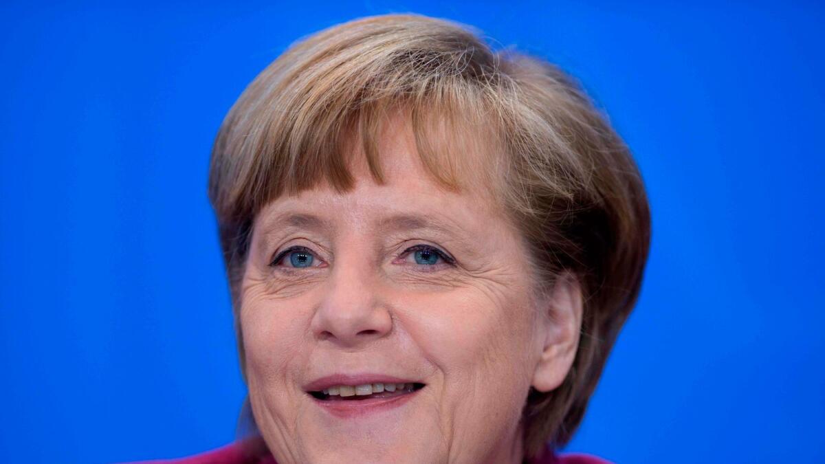 German Chancellor Angela Merkel smiles during a press conference.