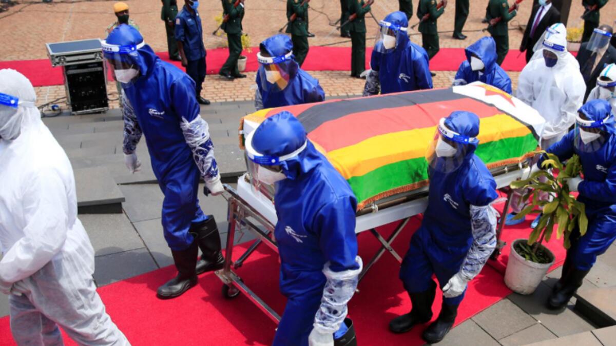 Pallbearers carry a coffin at the burial of two cabinet ministers and a retired general who died after contracting the coronavirus disease (Covid-19) in Harare, Zimbabwe. — Reuters