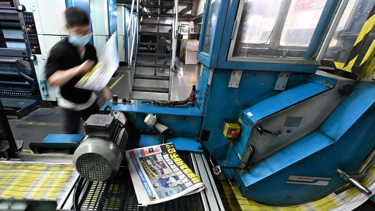 An employee working at the printing facility of the Apple Daily newspaper in Hong Kong. Photo: AFP