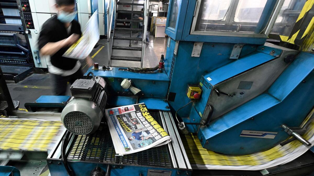 An employee working at the printing facility of the Apple Daily newspaper in Hong Kong. Photo: AFP