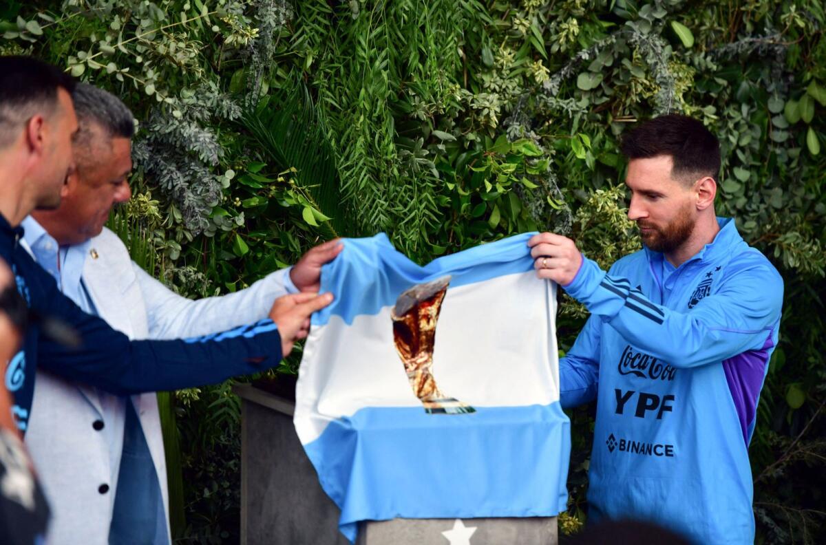 President of the Argentine Football Association, Claudio Tapia (second left), and Lionel Messi unveiling a plaque during the renaming of AFA's training camp as 'Lionel Andres Messi' in honour of the Argentine star, in Ezeiza, Buenos Aires Province. — AFP