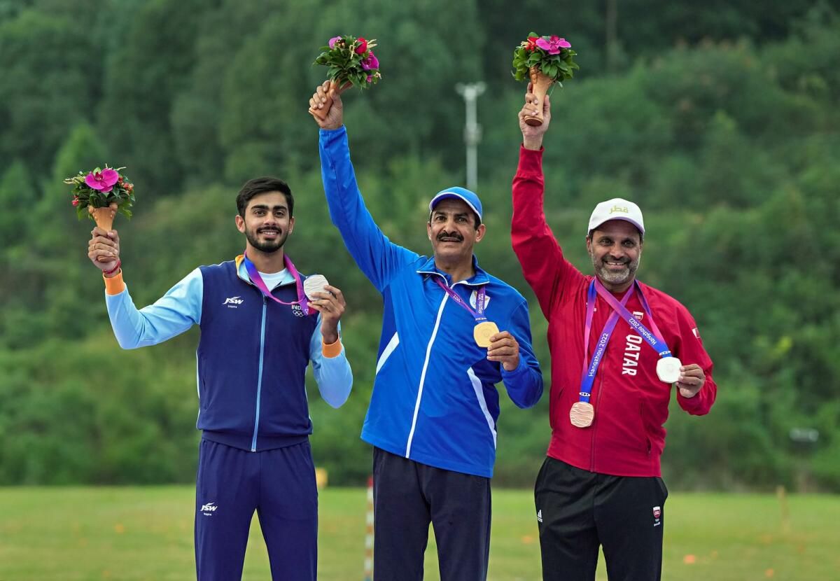 Silver medallist Anant Jeet Singh Naruka (left) of India, gold medallist Abdullah Alrashidi (centre) of Kuwait and bronze medallist Nasser Al-Attiyah of Qatar during the presentation ceremony of men's skeet event at the Asian Games. — PTI