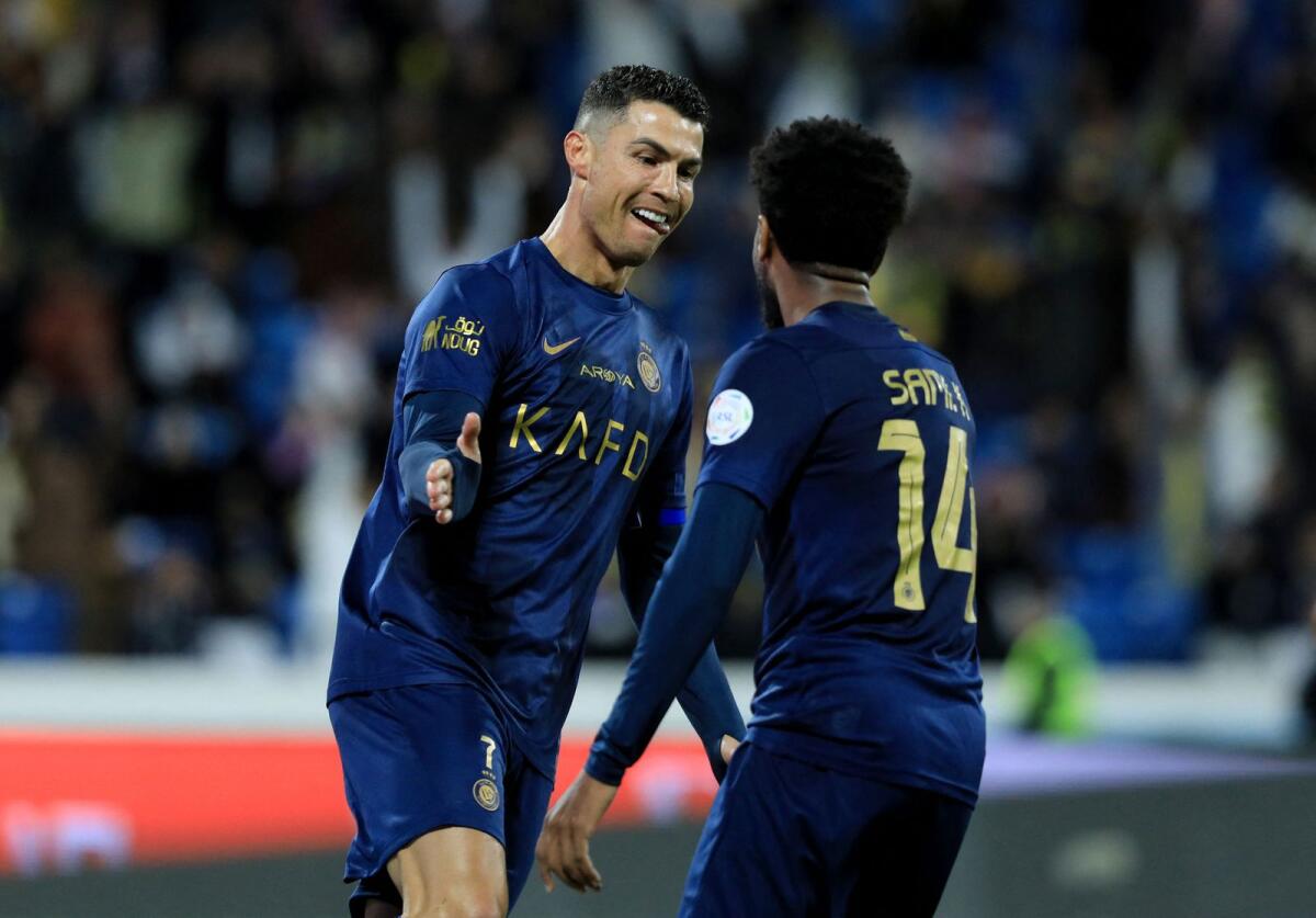Al Nassr's Cristiano Ronaldo celebrates a goal with teammate Abdulmajeed Al-Sulaiheem. — Reuters