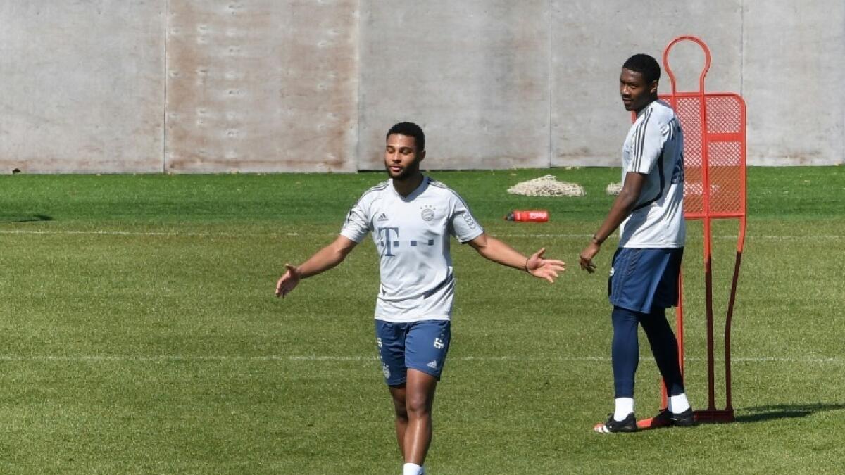 Bayern Munich stars Serge Gnabry left) and David Alaba (right) kept their distance in training on Monday. - AFP