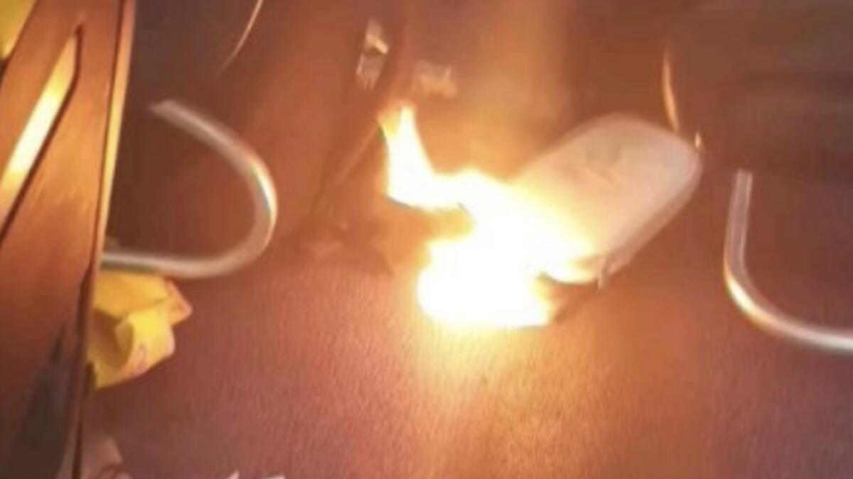 Video: Passengers flee plane after mobile phone bursts into flames