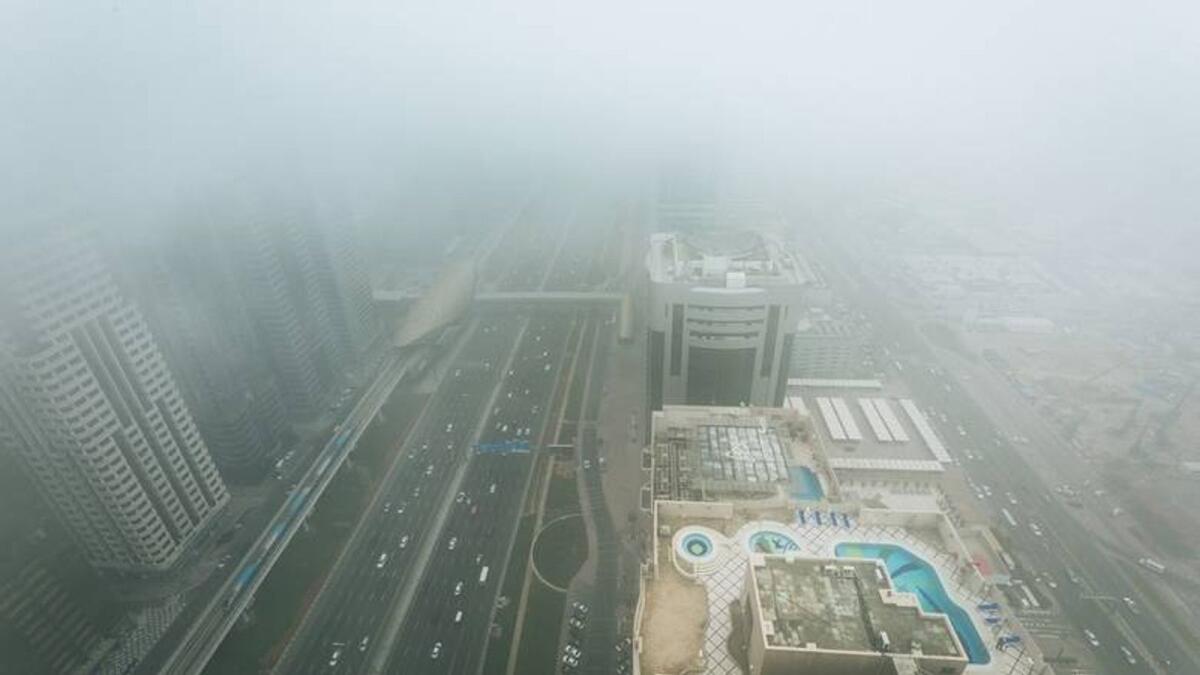 Dense fog rolls over Sheikh Zayed road as seen from Level 43 of Four Points by Sheraton, Dubai.
