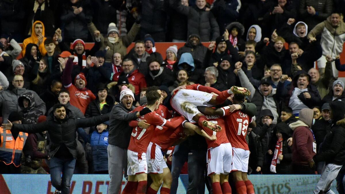 Nottingham Forest players celebrate their goal against Arsenal. (AP)