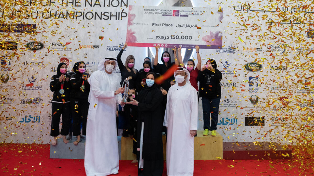Al Wahda Jiu-Jitsu Club with the overall championship trophy. -- Supplied photo