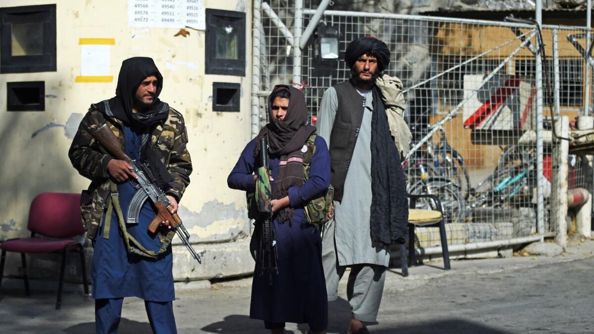 Taliban fighters stand guard at an entrance gate of the Sardar Mohammad Dawood Khan military hospital in Kabul on November 3, 2021, a day after an attack claimed by the Taliban's hardline rivals the Islamic State-Khorasan (IS-K), in which at least 19 people were killed. - A Taliban military commander in Kabul, Hamdullah Mokhlis, was among the fighters killed when his men responded to an Islamic State attack on a hospital, officials said on October 3. (Photo by WAKIL KOHSAR / AFP)