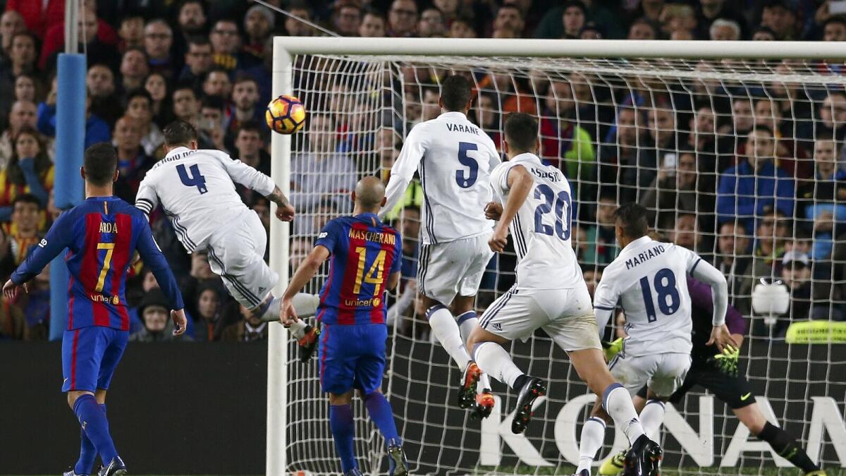 Real Madrid captain Sergio Ramos (left) headed a 90th-minute equaliser as Los Blancos came from behind to draw 1-1 with Barcelona in Saturday afternoon’s El Clasico at Camp Nou. — Reuters