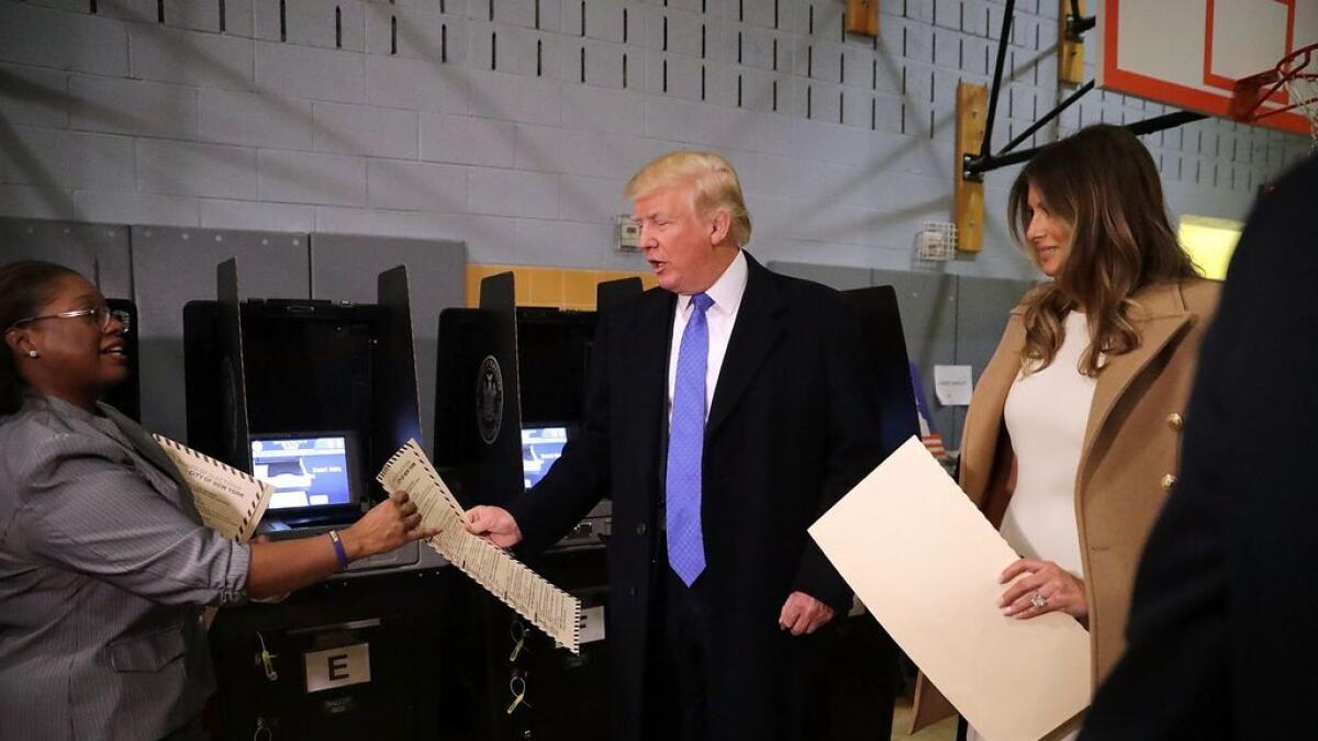 Republican presidential nominee Donald Trump (C) and his wife Melania Trump casts their votes on Election Day at PS 59 November 8, 2016 in New York City.