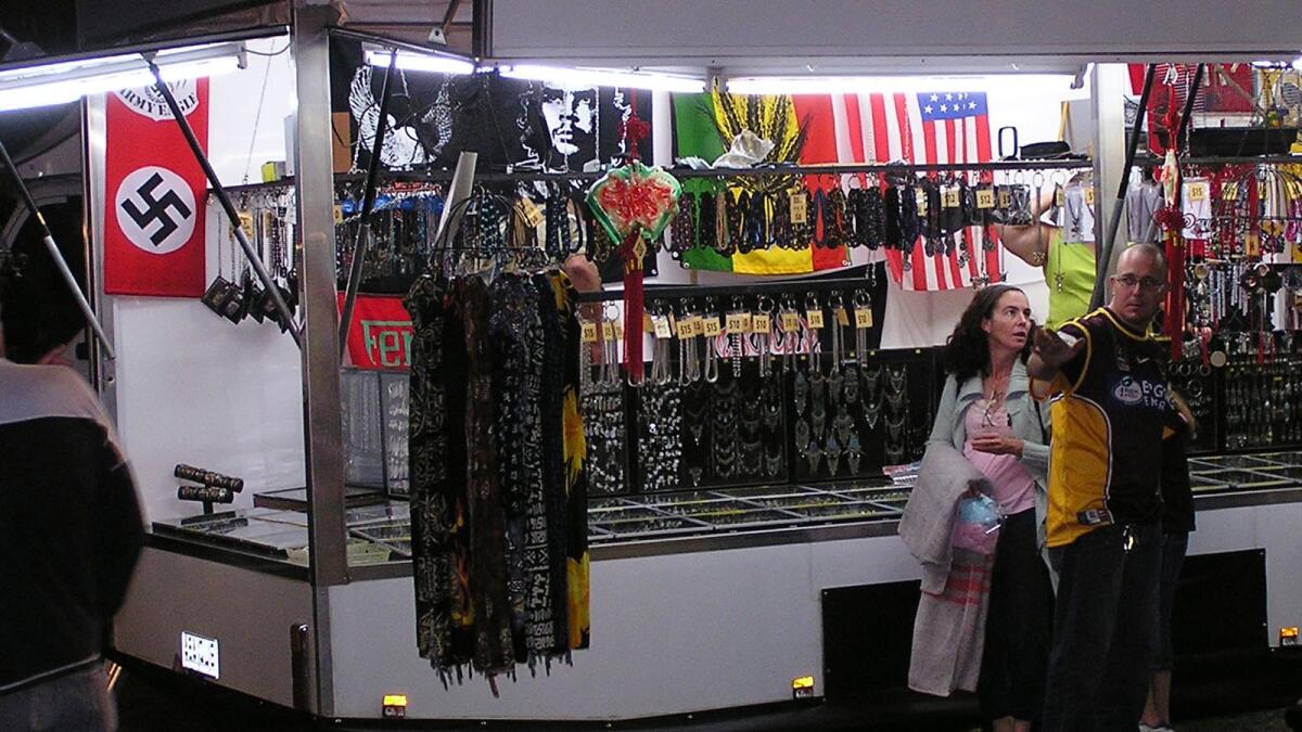 A swastika flag, left, is displayed for sale at a store at the Gladstone Harbour Festival in central Queensland, April 11, 2006. -- AP