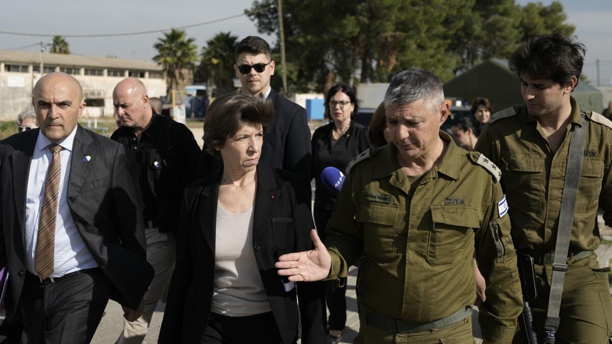 French Foreign Minister Catherine Colonna talks with Israeli Col. Olivier Rafowicz as she arrives at the Shura military base, central Israel. — AP