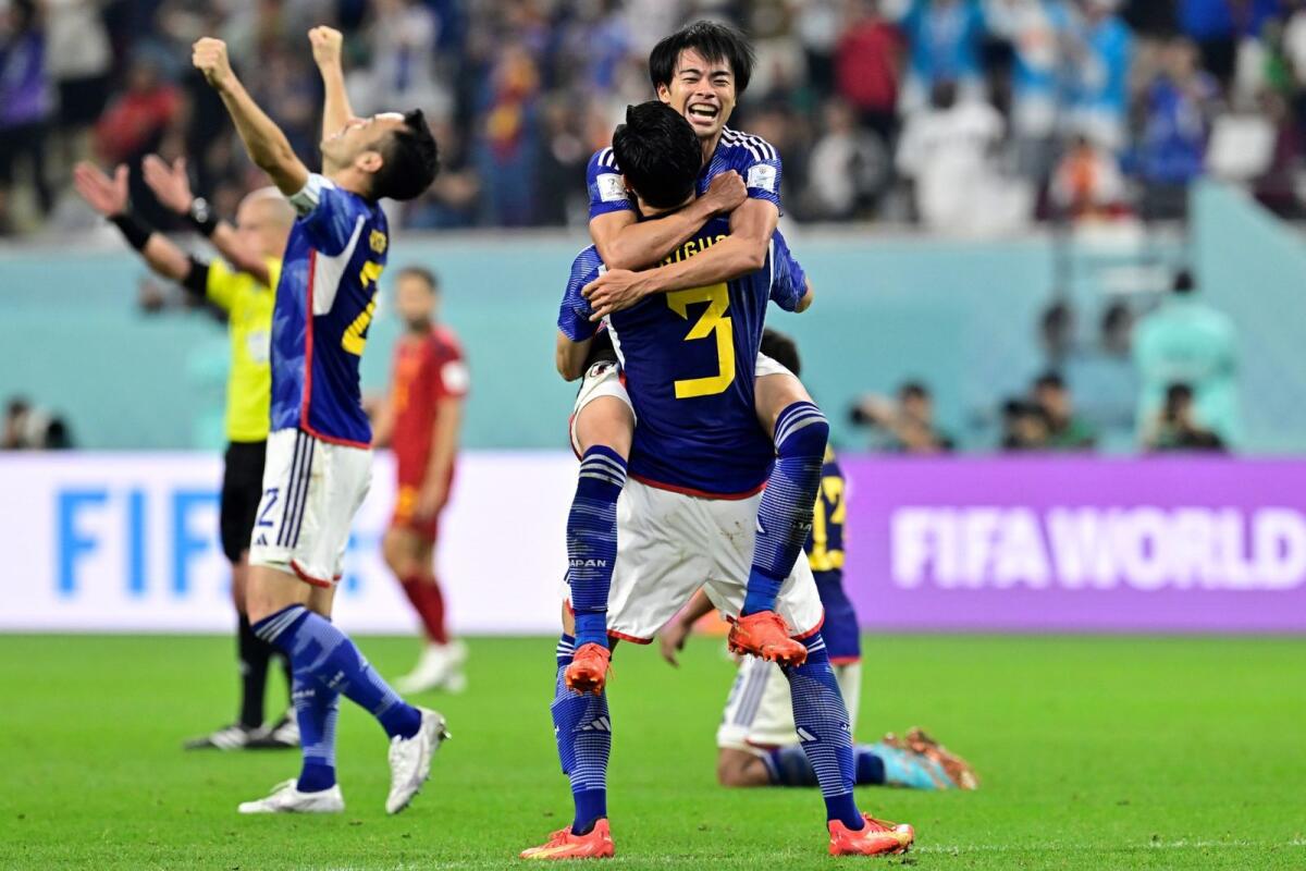 Japan's teammates celebrate after winning the Qatar 2022 World Cup Group E match between against Spain. Photo: AFP