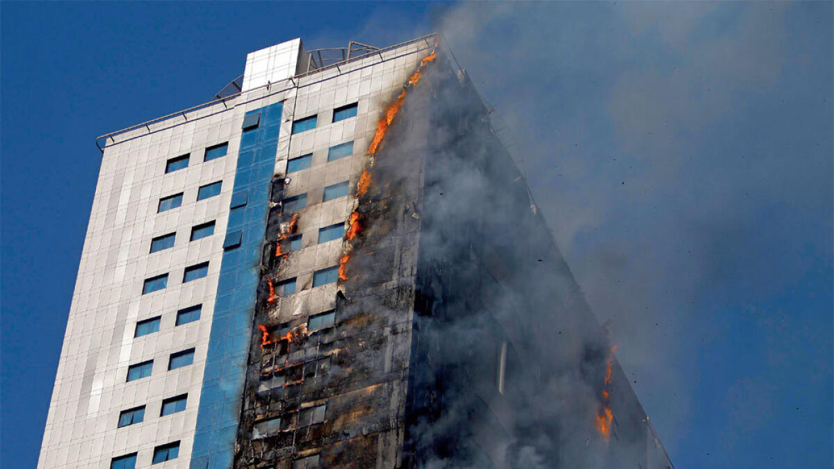 The residential building on fire at King Faisal Street in Sharjah on Thursday.