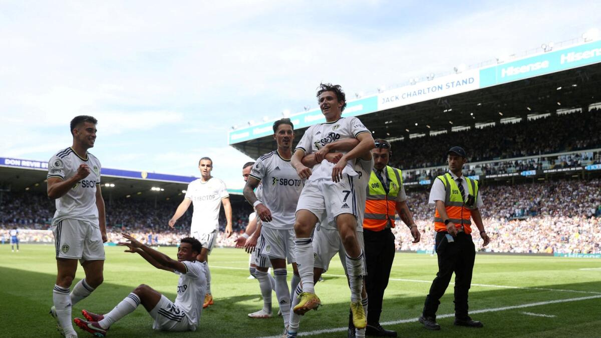 Leeds United's Brenden Aaronson celebrates after scoring their first goal with teammates. (Reuters)