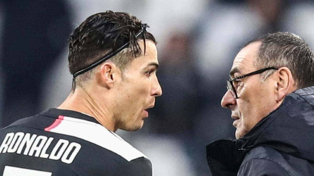 Juventus star Cristiano Ronaldo and coach Maurizio Sarri (right) have agreed to take pay cuts. - AFP file