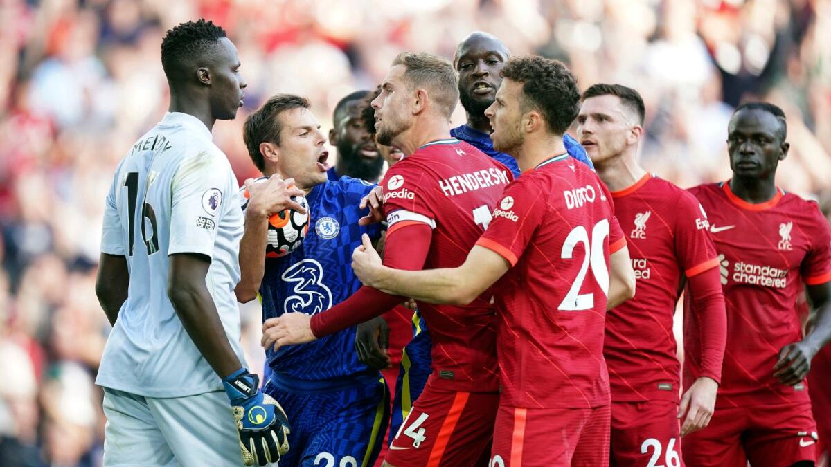 Chelsea's Cesar Azpilicueta (second left) and Liverpool's Jordan Henderson (third left) clash following Liverpool's equaliser during the Premier League match at Anfield.— AP