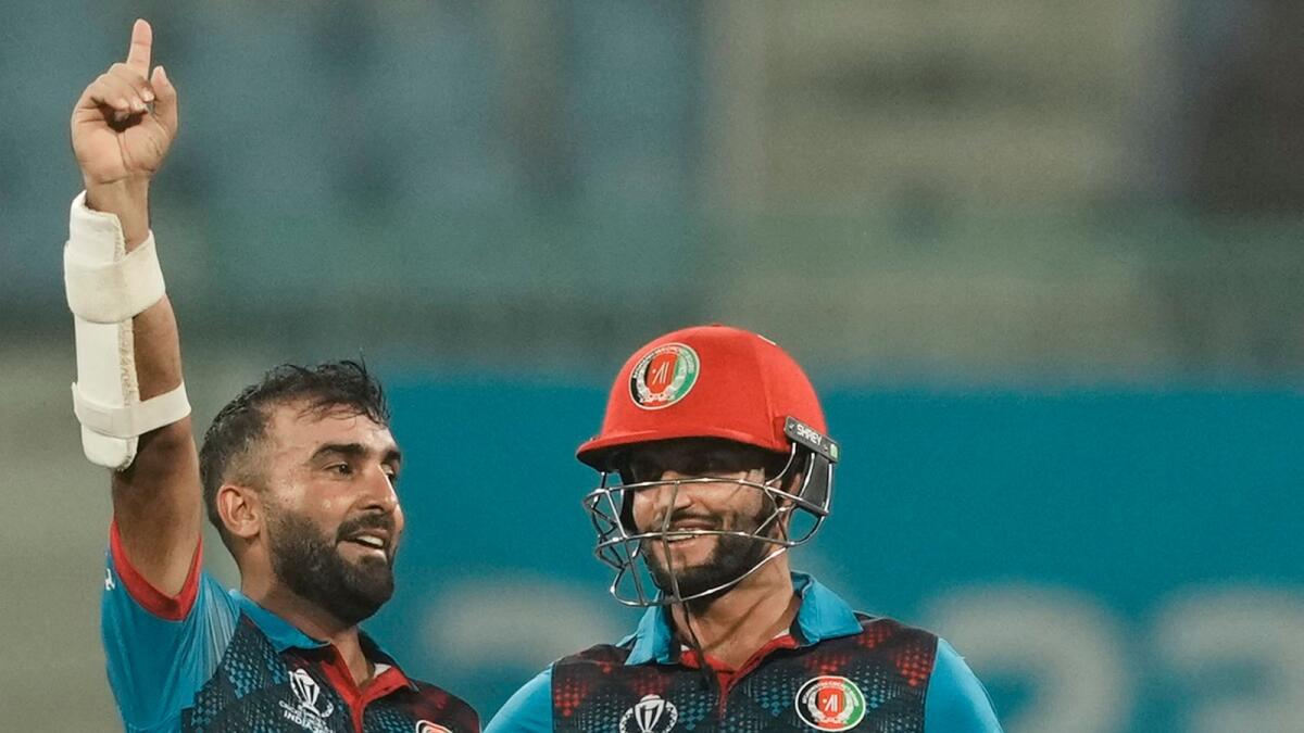 Afghanistan's batters Hashmatullah Shahidi and Azmatullah Omarzai celebrate after winning the ICC Men's Cricket World Cup 2023 match against Netherlands,on Friday. - PTI
