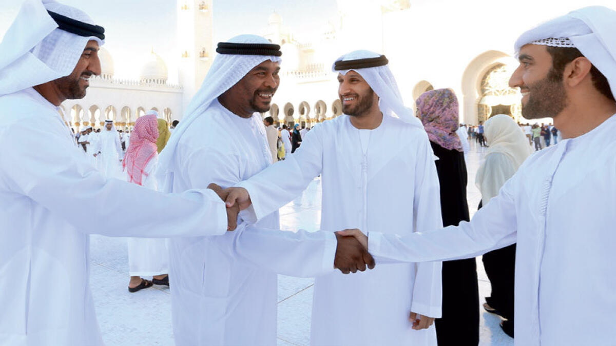 A FEELING OF CAMARADERIE ... Emiratis greet each other after offering prayers at the Zayed Grand Mosque, Abu Dhabi.