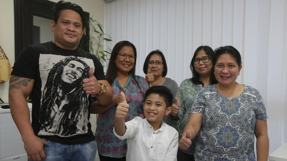 Peter Rosalita (centre) with (l-r) father Ruel Rosalita, music teacher Rose Abegail, godmother Nelia Roque, aunt Mary Jane and mother Vilma Villegas.