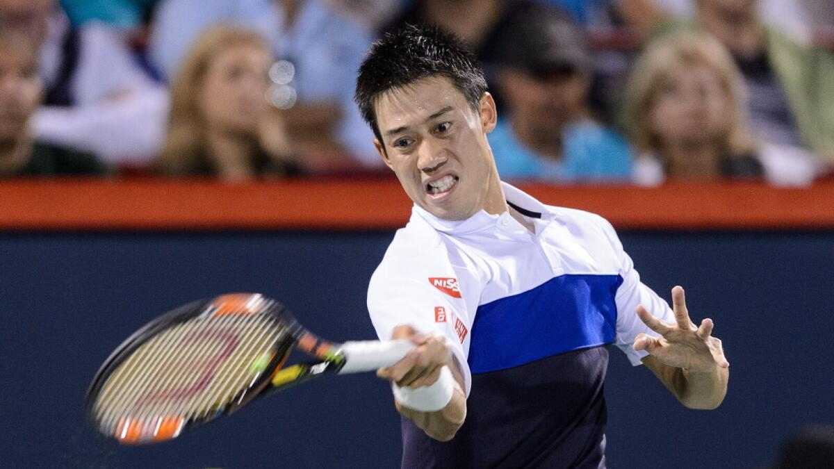 Kei Nishikori of Japan hits a return against Rafael Nadal of Spain during day five of the Rogers Cup at Uniprix Stadium on August 14, 2015 in Montreal, Quebec, Canada.  