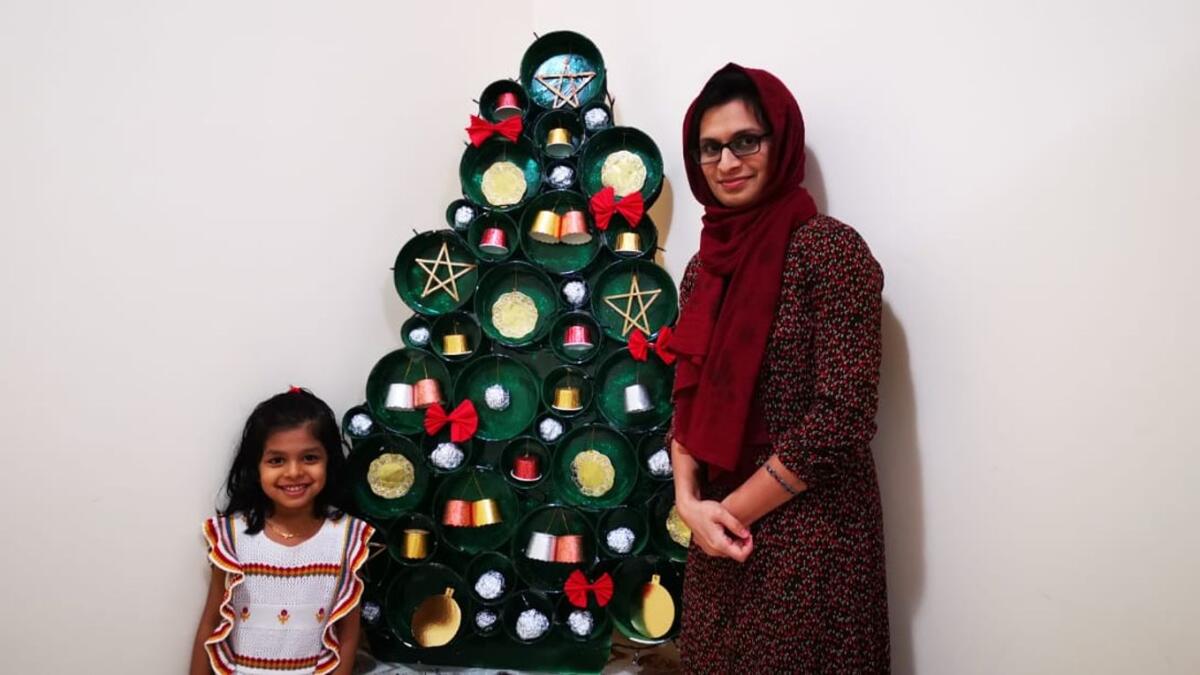 Afiya and her daughter pose alongside the sustainable Christmas tree. Photo: Saman Haziq