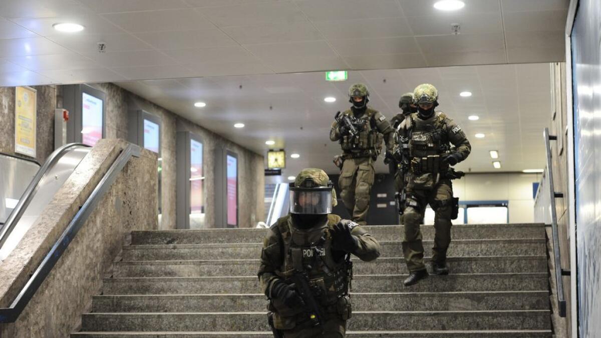 Heavily armed police forces walk through the underground station Karlsplatz (Stachus) after a shooting in the Olympia shopping centre was reported in Munich, southern Germany 