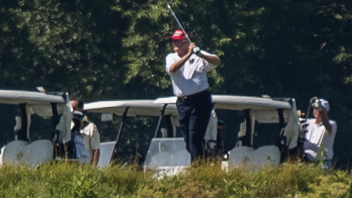 US President Donald Trump plays golf at Trump National Golf Club in Sterling, Va., as seen from the other side of the Potomac River in Darnestown. Photo: AP