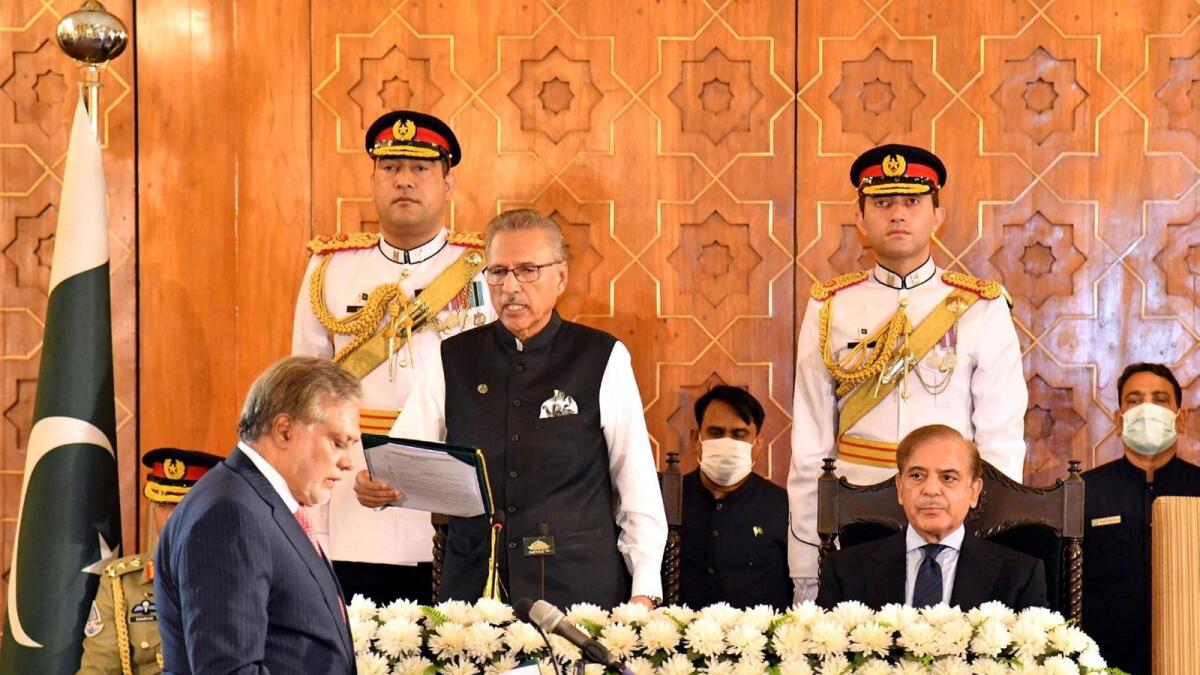 Pakistan's new Finance Minister Ishaq Dar takes oath from the Pakistan's President Arif Alvi, in Islamabad on September 28, 2022. — Reuters