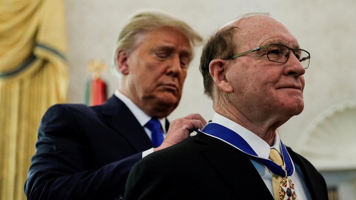 U.S. President Donald Trump awards the Presidential Medal of Freedom to U.S. Olympic gold medallist wrestler Dan Gable at the White House on December 7, 2020.