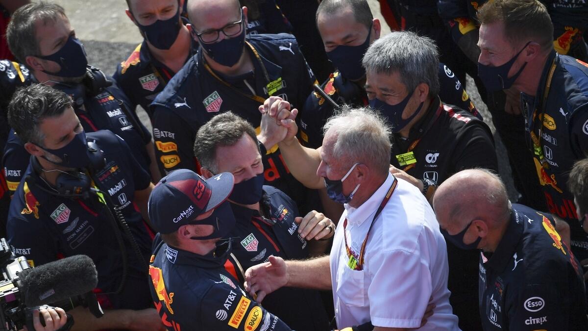 Red Bull driver Max Verstappen of the Netherlands, with cap, celebrates with his team after winning the 70th Anniversary Formula One Grand Prix