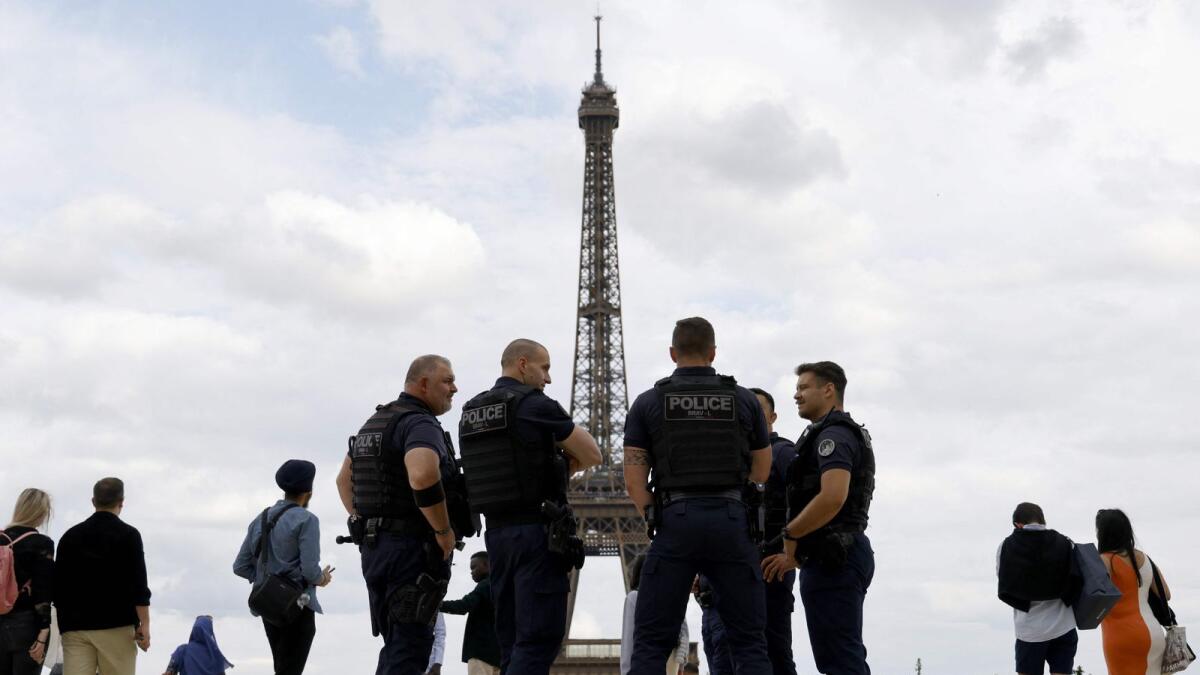 French police officers of the Repression of Violent Action Brigade (Brav or Brigade de repression de l'action violente) stand on the Trocadero Plaza, with the Eiffel Tower in background in Paris, on Wednesday. – AFP