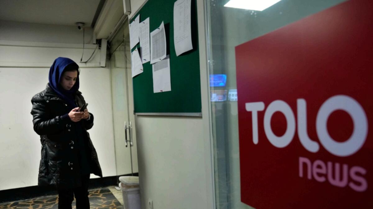 Afghan journalist Madina Morwat, checks her mobile at TOLO TV newsroom, in Kabul. — AP