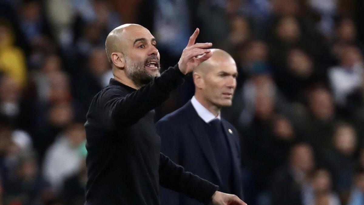 Manchester City manager Pep Guardiola reacts alongside Real Madrid coach Zinedine Zidane. - Reuters file