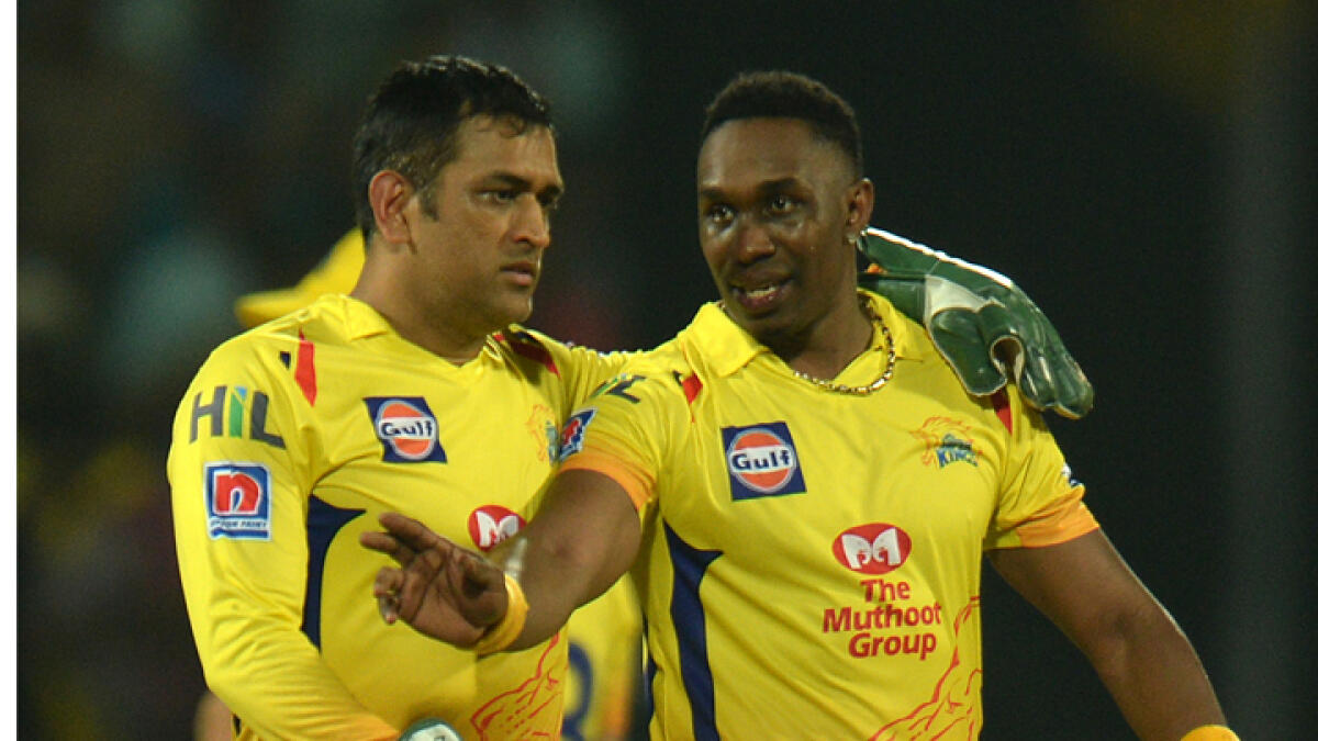 M.S. Dhoni and Dwayne Bravo interact during a previous edition of the IPL. - AFP