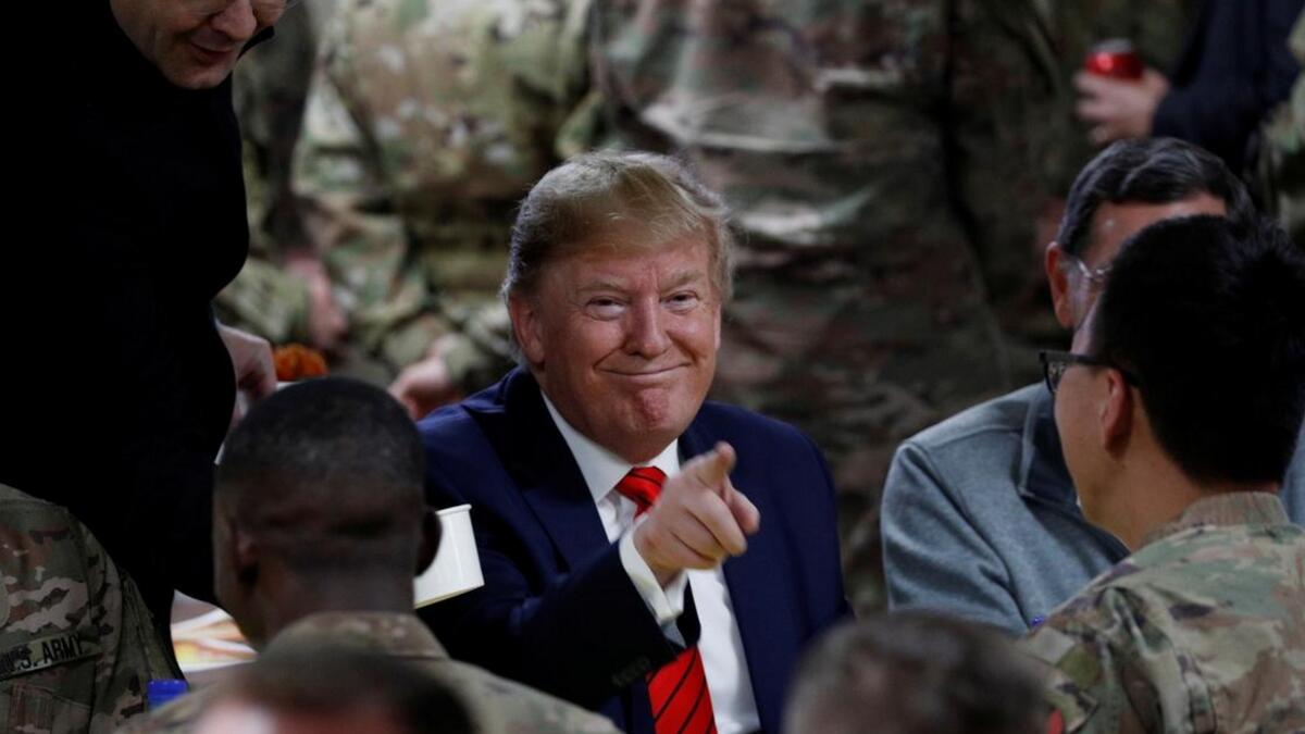 President Donald Trump eats dinner with US troops at a Thanksgiving dinner event during a surprise visit at Bagram Air Base in Afghanistan, November 28, 2019. Reuters