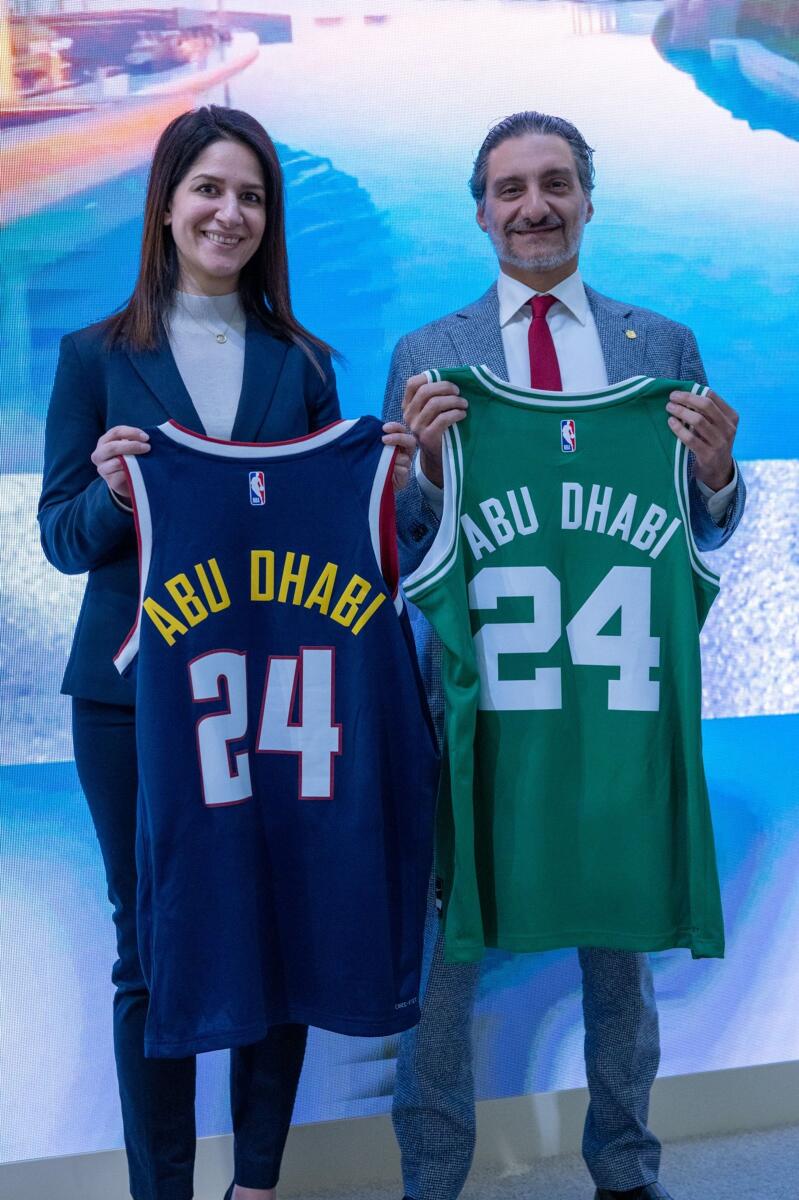 Saleh Mohamed Al Geziry and Dina Ahmad, NBA EME Vice President, New Business Ventures &amp; Global Partnerships with the team jerseys. - Supplied photo