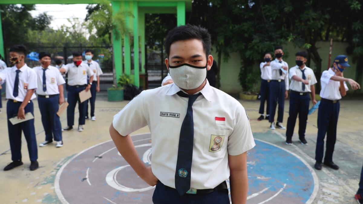 Students wear face masks as a precaution against the coronavirus during the first day of school reopening in Bekasi on the outskirts of Jakarta, Indonesia. Photo: AP