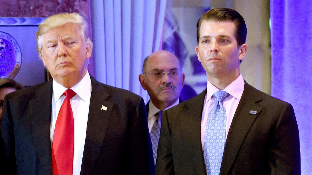 In this file photo taken in 2017 former US President-elect Donald Trump along with his son Donald, Jr., seen at Trump Tower in New York, as Allen Weisselberg (centre), chief financial officer of The Trump, looks on. Photo: AFP