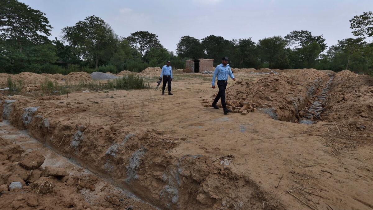 Police officers guard the site of a proposed Hindu temple in Islamabad.
