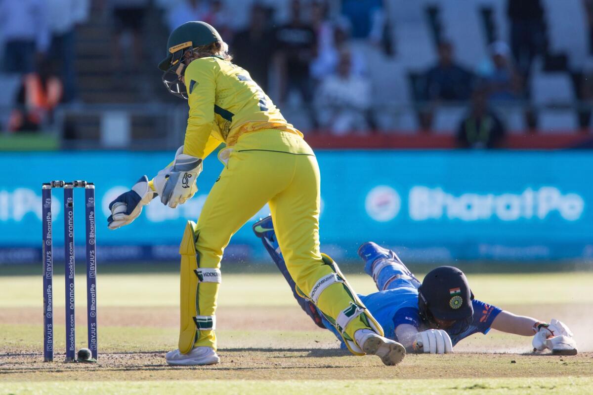 India's Deepti Sharma dives as Australia's Alyssa Healy attempts the run out. — AP