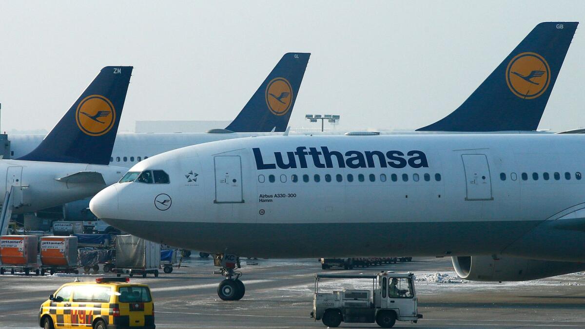 Runway operations vehicles operate beside a Deutsche Lufthansa AG Airbus A330-300 aircraft at Frankfurt airport in Frankfurt, Germany. — File photo