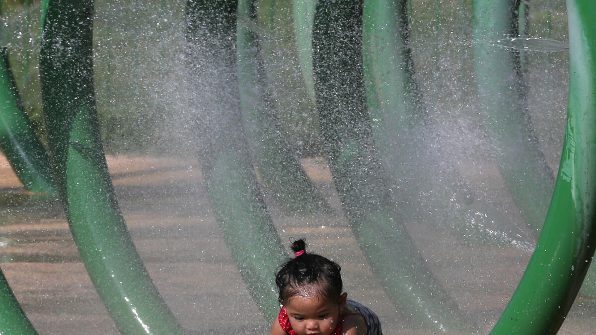 A child enjoys playing in the water at a park in Abu Dhabi.-Photo by Ryan Lim/Khaleej Times