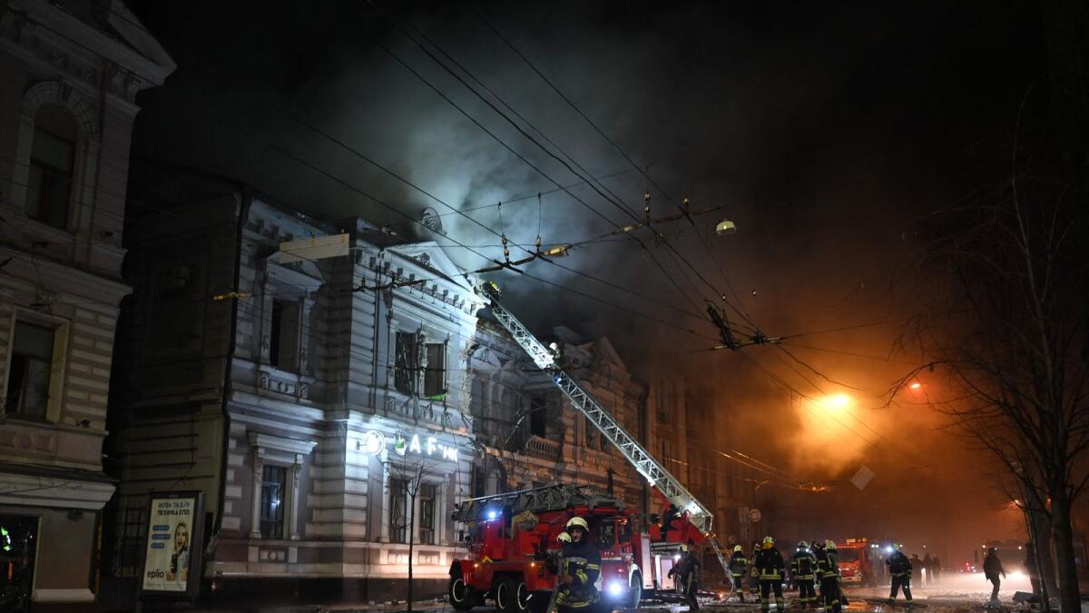 Firefighters extinguish a fire in a building after a Russian drone attack in Kharkiv. — AFP