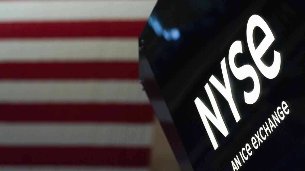An NYSE sign is seen on the floor at the New York Stock Exchange in New York. - AP
