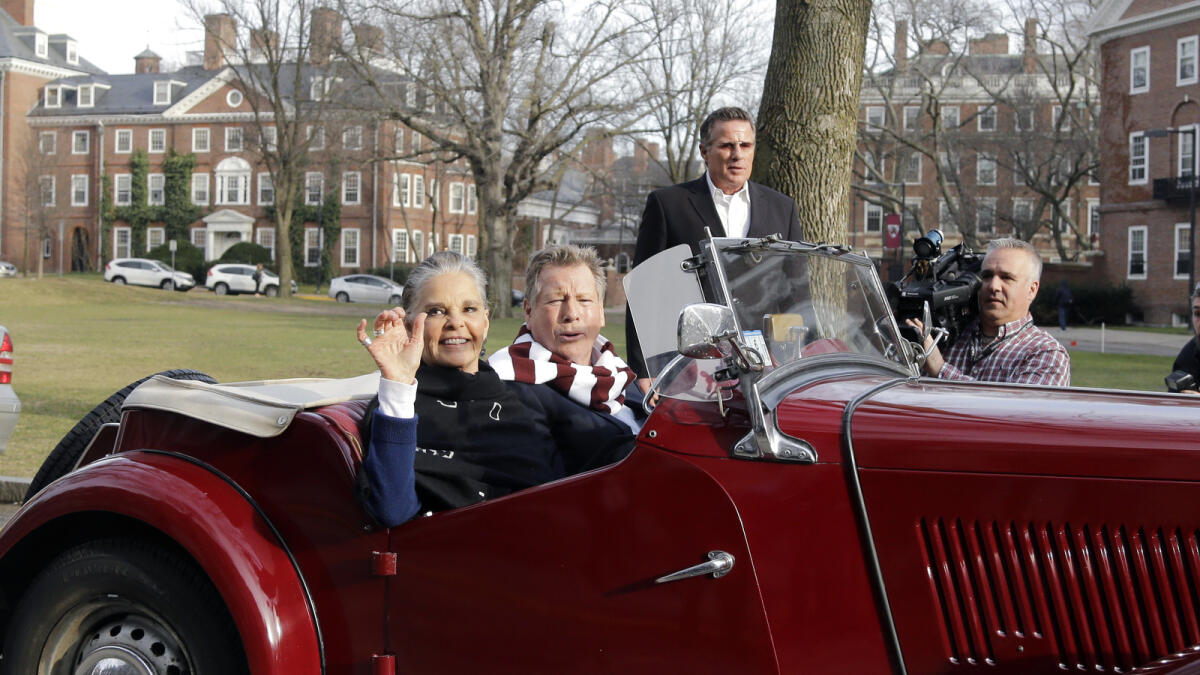 MacGraw and O’Neal in an antique MG convertible on the campus of Harvard University  on Monday