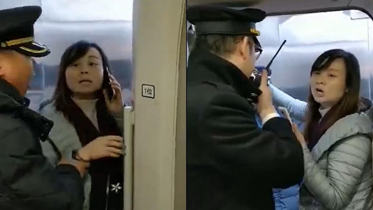 Video: Woman blocks door, delays train for husband