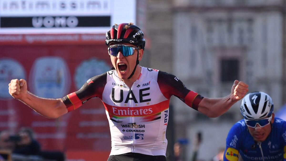UAE Team Emirates' Tadej Pogacar of Slovenia celebrates as he crosses the finish line of the 115th edition of the Giro di Lombardia. (AFP)
